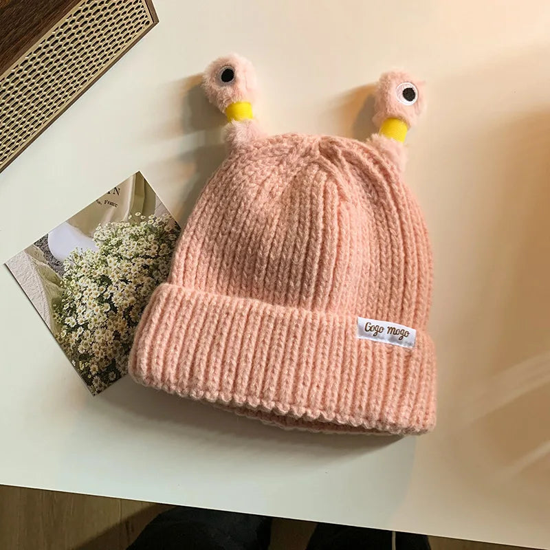pink knit beanie with Antennas design on a light surface
