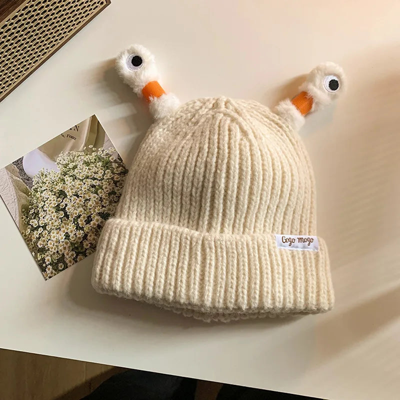 Beige knit beanie with Antennas design on a light surface
