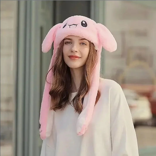 Person wearing a pink bunny hat with long ears indoors