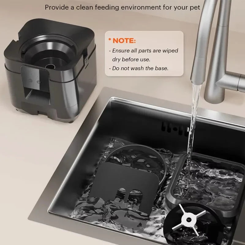 Pet feeding station being rinsed in a sink with water flowing over it, on a beige countertop.